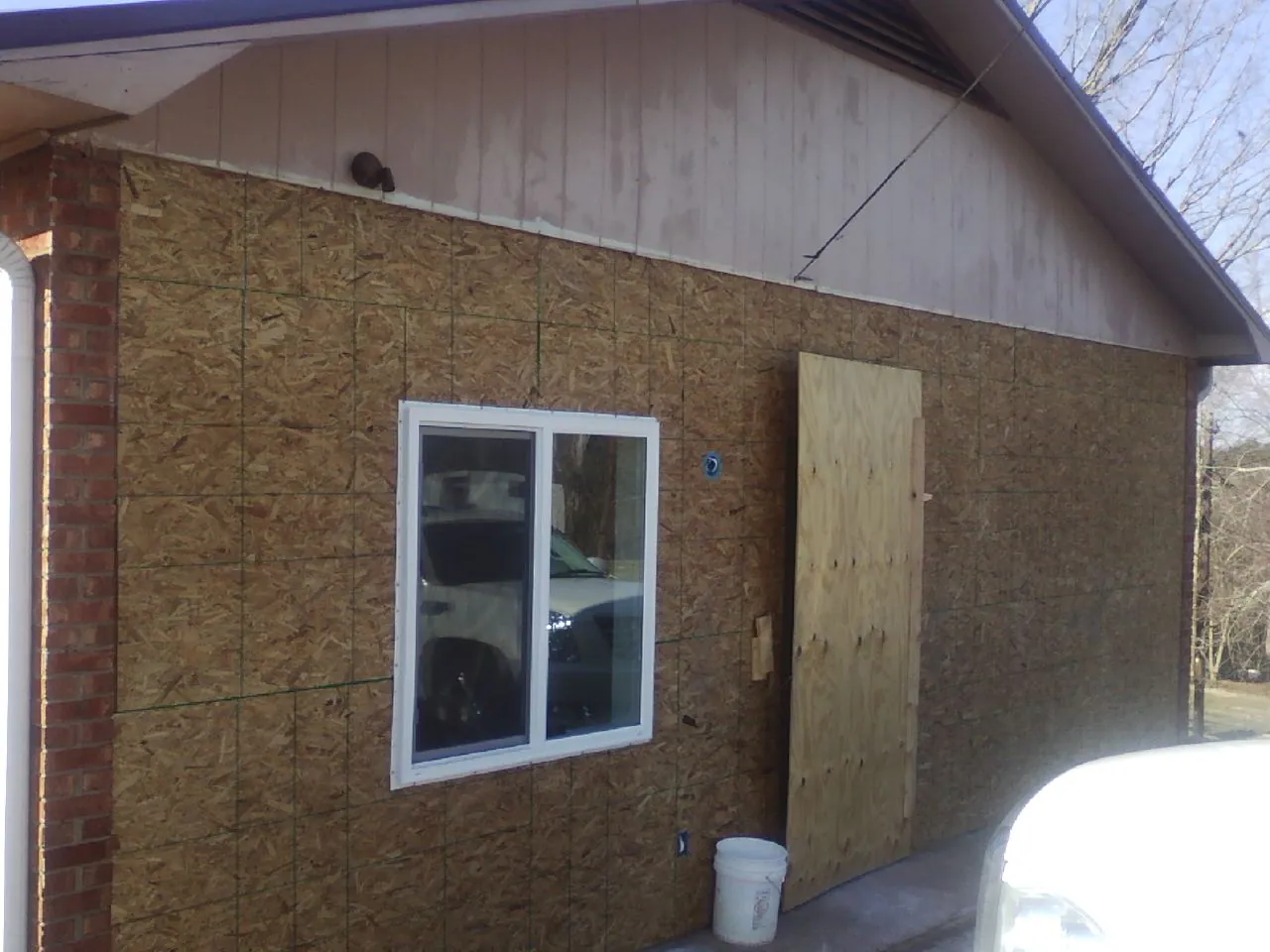 OSB sheathing on a garage addition wall before siding in Clarksburg